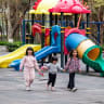 Children are seen at a playground.