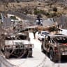 Israel military vehicles drive along the border fence into Israel, near the town of Majdal Shams, in the Israeli-annexed Golan Heights, on July 17, 2025.