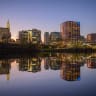 The Hartford skyline comes to light reflected in the Connecticut River and seen from Great River Park in East Hartford, Connecticut, on November 11, 2024. 