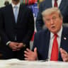 US President Donald Trump speaks as he sits behind an airport model as he makes an announcement about a renovation of Washington Dulles International Airport in the Oval Office at the White House in Washington, DC, US, July 29, 2026.  