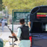 A security officer in plain clothes walks with his gun outside the office of the Rangers, a paramilitary force, following an explosion and gunfire reported on Saturday night in Karachi, Pakistan, June 28, 2026.