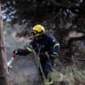 A firefighter works to extinguish a wildfire burning next to the village of Krya Vrysi on the island of Crete, Greece, July 29, 2026.