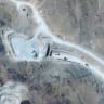 SATELLITE VIEW shows vehicles at an entrance to Pickaxe Mountain tunnels, near Natanz nuclear facility, in Iran, June 21.