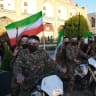 A group of Basiji men in military fatigue and armed seen in the middle of Naqsh-e Jahan Square mounted on their motorcycles on the occasion of Imam Reza's (8th Shia Imam) birthday while holding Iranian flags with images of the new Supreme Leader Mojtaba Khamenei on April 29, 2026.