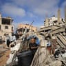 (FILE PHOTO) A Palestinian man inspects the site of Wednesday's Israeli strike on a house whose residents were pre-warned by the Israeli military to evacuate, in Gaza City, July 30, 2026.