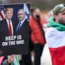 A person holds a placard with a picture of US President Donald Trump alongside Prime Minister Benjamin Netanyahu, as protesters gather near the United Nations office in Geneva, Switzerland, February 17, 2026