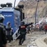 Moroccan security forces clash with migrants attempting to cross into Spain's North African enclave of Ceuta near the town of Fnideq, on the Morocco-Spain border, on July 31, 2026. 