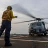A US Navy MH-60R Sea Hawk helicopter is prepared for flight aboard USS Michael Murphy (DDG 112) as the warship supports the U.S. blockade against Iran while sailing in regional waters.
