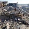Palestinians inspect a site of an Israeli strike on a house that was pre-warned by the Israeli military to evacuate on Saturday before the strike was carried out later that day, in Deir Al-Balah, central Gaza Strip, July 19, 2026. 