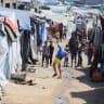 Children play as displaced Palestinians shelter at a tent camp, in Gaza City, July 31, 2026.