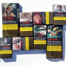 Pictorial warnings on cigarette packaging, now required by law. 