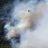 A firefighting helicopter flies over wildfire near the village Agia Paraskevi, Greece, August 2, 2026.