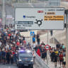 Police officers and Spanish soldiers escort a big group of migrants to the border to take them out of Spain, after mass crossings of migrants on foot and by sea from Morocco into Spanish territory, in Ceuta, Spain, August 1, 2026.