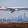 A Boeing 777 passengers aircraft of American Airlines arrives from Milan at JFK International Airport in New York as the Manhattan skyline looms in the background on February 7, 2024; Illustrative.