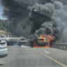 A vehicle is seen engulfed in flames on Highway 1 near the Shoresh Interchange on August 3, 2026.