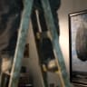 "The Castle of the Pyrenees" a painting by famous Belgian artist Rene Magritte is seen on a wall as a laborer on a ladder prepares the Israel Museum of Jerusalem for a re-opening.