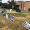 Campaign signs outside of an early voting site in Oak Park, Michigan, on August 2, 2026.