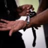 A prison officer handcuffs a colleague as part of a drill at the third organised crime unit (drug-trafficking district) during a press tour at Reau prison, near Paris on July 30, 2026.