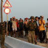 Members of the military escort migrants in Ceuta, Spain, following recent mass crossings of migrants on foot and by sea from Morocco into Spanish territory, August 1, 2026.