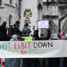 Protesters hold signs outside the Royal Courts of Justice, after High Court judges ruled the British government’s decision to designate pro‑Palestinian group Palestine Action as a terrorist organisation unlawful, in London, Britain, February 13, 2026.
