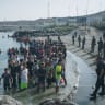 MEMBERS OF the Guardia Civil guard migrants on Tarajal beach after they crossed the border from Morocco into the tiny Spanish North African enclave of Ceuta last week. 