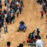 Illustrative: A man performs stunts with an all-terrain vehicle (ATV) on sand dunes near destroyed buildings in the Zahra neighbourhood, southwest of Nuseirat in the central Gaza Strip, on February 6, 2026.