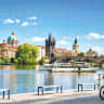 BEAUTIFUL PRAGUE along the Vltava River embraces Kafka as a global icon, even offering city tours by tricycle.