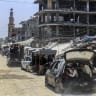 Palestinians live among buildings destroyed during the recent war in Khan Yunis, in the southern Gaza Strip, July 31, 2026.