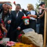  Nissim Louk (L) places a memorial candle bearing an image of his daughter Shani Louk at her gravesite as Israeli Knesset member Pnina Tamano-Shata (2nd L) looks on May 19, 2024 in Srigim-Li On, Israel.