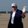 U.S. President Donald Trump waves as he disembarks Air Force One at Joint Base Andrews, Maryland, US, August 9, 2026.