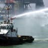 A barge sprays water 29 April 2004, during the opening of the Neka oil terminal on the Caspian Sea, 340 kms northwest of Tehran in Mazandaran province, a swap agreement with several Caspian oil producers launched several months ago; illustrative