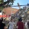 Rescue workers and residents stand atop a collapsed building in the aftermath of an earthquake in Cali, Colombia, August 10, 2026