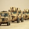 Libyan army vehicles take part in the "Dara' al-Karama 2" military exercises, conducted by the Libyan National Army (LNA), under the command of Field Marshal Khalifa Haftar, in the Ras al-Alba region in southeastern Libya on May 16, 2026. 