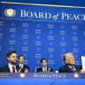 US Vice President JD Vance, Jared Kushner, and US Secretary of State Marco Rubio look on as US President Donald Trump holds up a resolution document that he signed during the inaugural meeting of the Board of Peace at the US Institute of Peace in Washington, DC, on February 19. 
