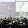 US Army personnel, IDF personnel, and other international officials monitor screens displaying maps and imagery of the Gaza Strip inside the Civil-Military Coordination Center (CMCC) in November in Kiryat Gat. 