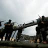 ARMED HAMAS terrorists display a home-made rocket during a military parade in Gaza City in 2014. 