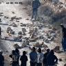 Settlers near Kusra blocking a road with rocks.