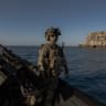 A member of "Timur's Special Forces Unit" of the Defence Intelligence of Ukraine waits on a military boat next to Snake Island, also known as Zmiinyi Island, located in the Black Sea, on August 14, 2025.