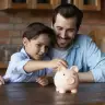 A father and son with a piggy bank