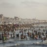People gather on a crowded beach in Gaza City in July.