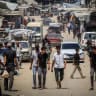 Palestinians are seen walking in Khan Yunis, southern Gaza Strip, August 12, 2026