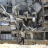 A Palestinian man walks past the rubble of buildings destroyed by the IDF in Khan Yunis, the southern Gaza Strip, August 11, 2026
