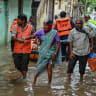 Members of the Disaster Response Force (DRF) evacuate residents at a flood-affected region following heavy monsoon rains in Hyderabad on September 27, 2025.