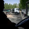 A driver resting in his electric truck while charging it at a station in Beijing, April 23, 2026.