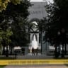 Members of the National Guard stand near the World War II Memorial, after the pool was reportedly vandalized with soap and graffiti, in Washington, DC, US, August 13, 2026.