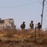 Israeli army soldiers stand near a Palestinian house which was besieged by Israeli settlers in Kusra village in the West Bank August 13, 2026.