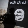 - A member of the Iraqi forces walks past a mural bearing the logo of the Islamic State (IS) group in a tunnel that was reportedly used as a training centre by the jihadists, on March 1, 2017, in the village of Albu Sayf, on the southern outskirts of Mosul. 