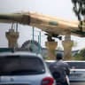 A replica of an Iranian air force F-4 Phantom fighter aircraft is displayed before traffic along a city square in Bandar Abbas in southern Iran on August 10, 2026.
