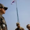 A South Korean flag flutters on the top of a 100-metre tower as soldiers stand guard at the Tae Sung freedom village near the Military Demarcation Line (MDL), inside the demilitarised zone separating the two Koreas, in Paju, South Korea, September 30, 2019. 