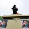 A security personnel stands guard as Iranians take part in a protest marking the annual al-Quds Day, on the last Friday of the holy month of Ramadan, in Tehran, Iran, March 13, 2026